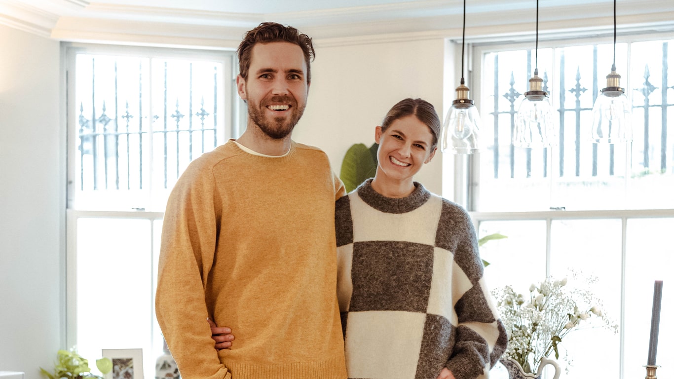 Sam and Tash Bradley standing in their flat 