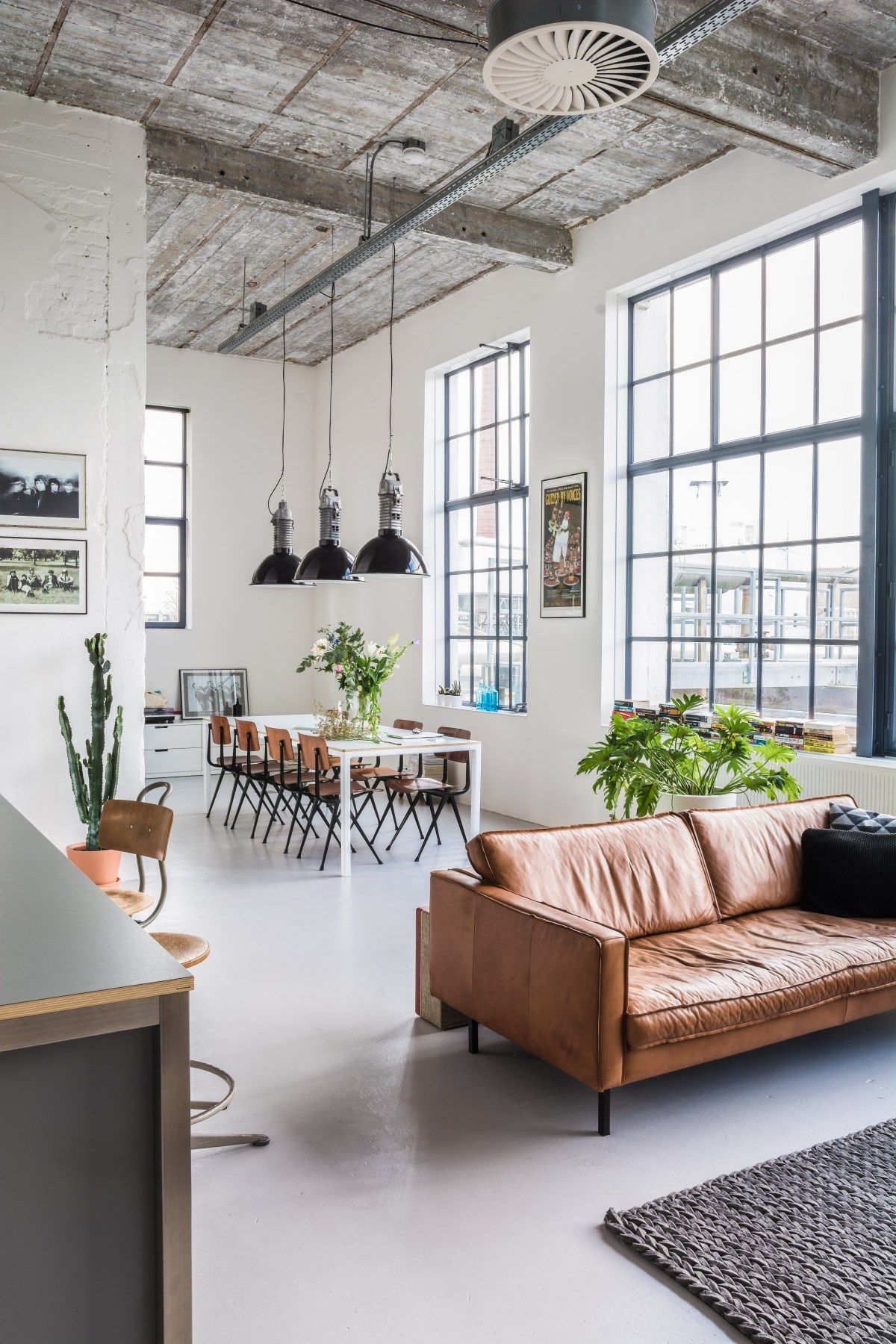 Industrial open layout loft with dark leather furnishings 