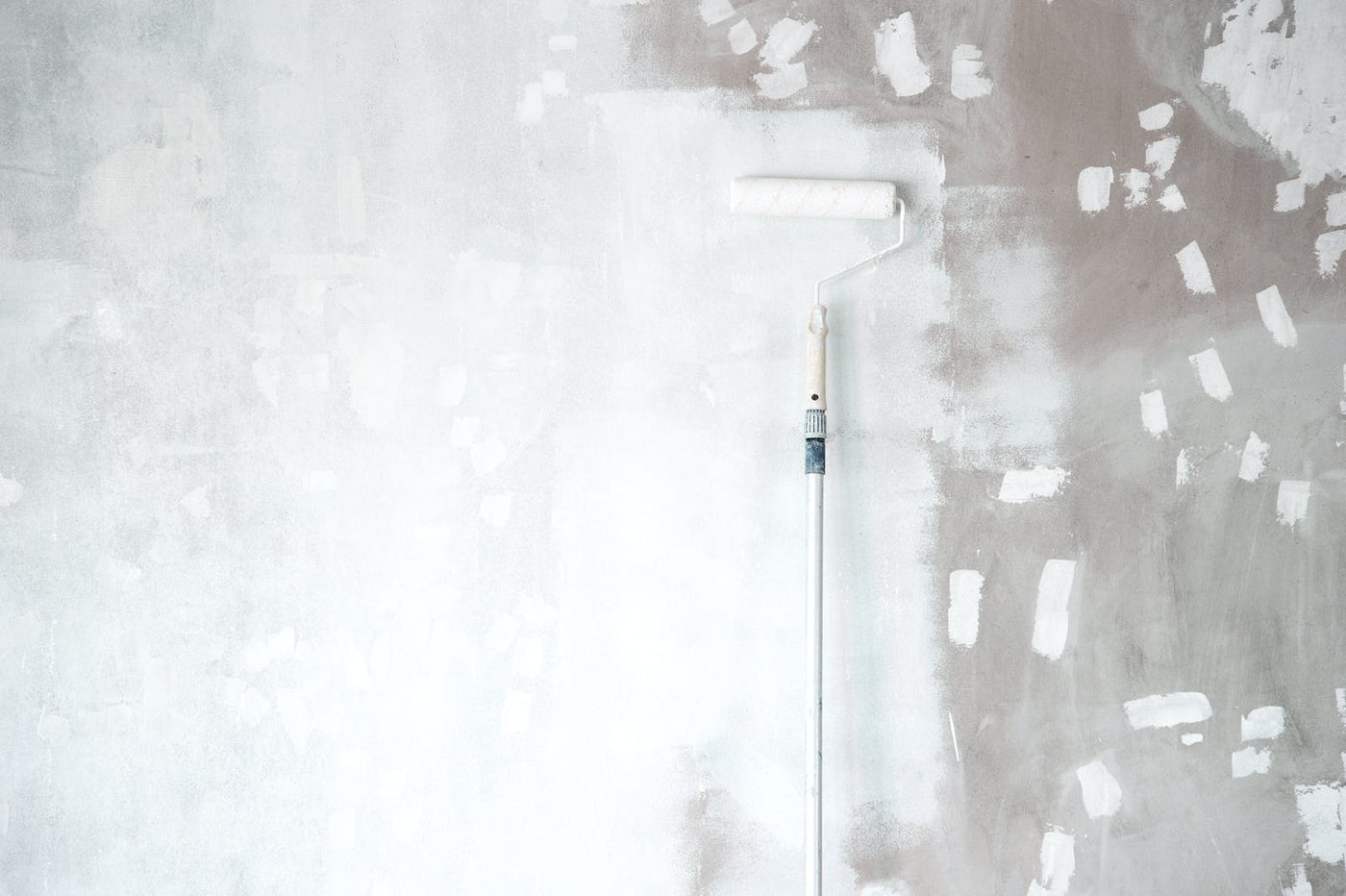White primer paint being applied to a wall